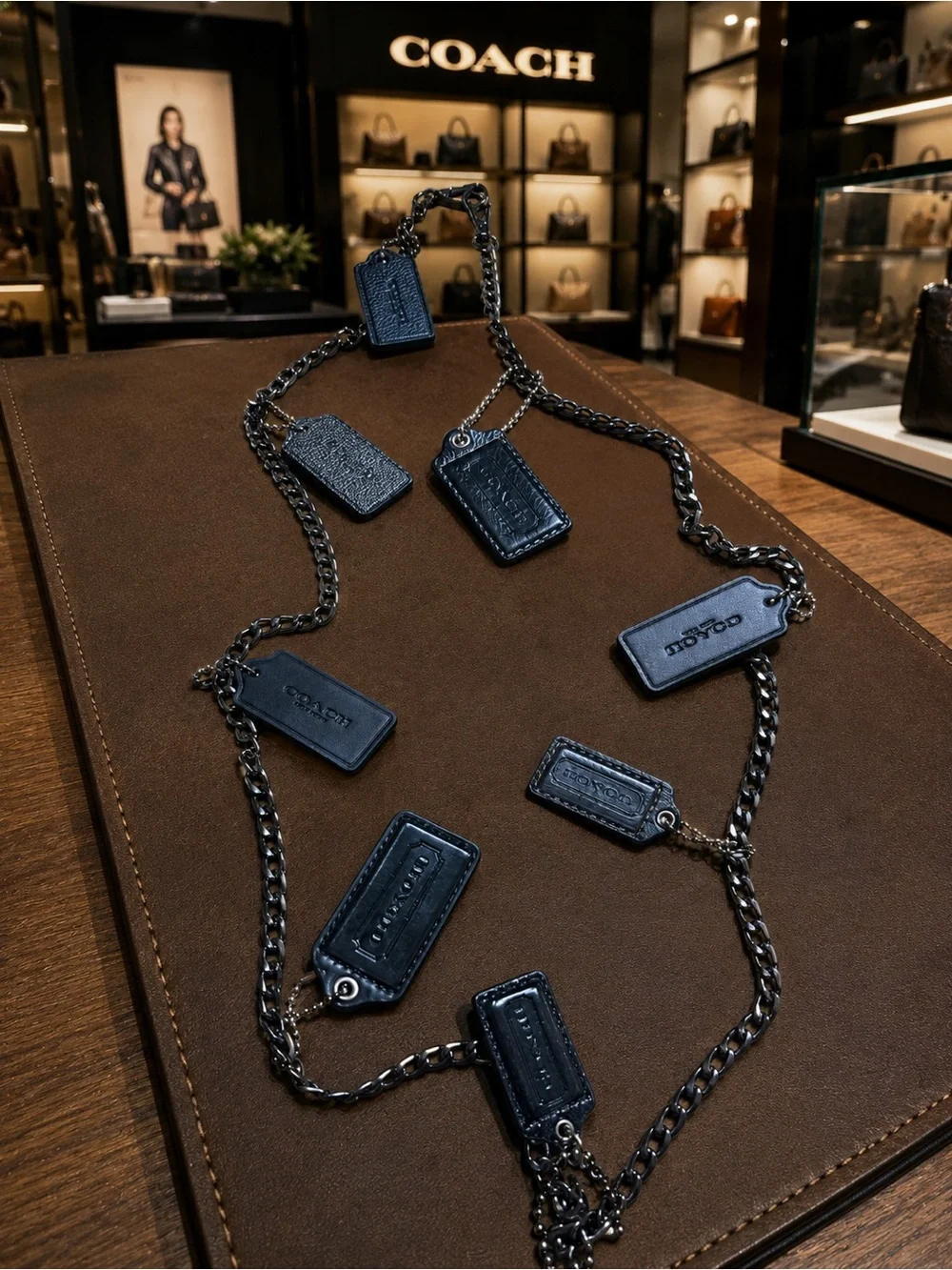Coach hanging hang tags (8) from a Gunmetal Chain Strap
